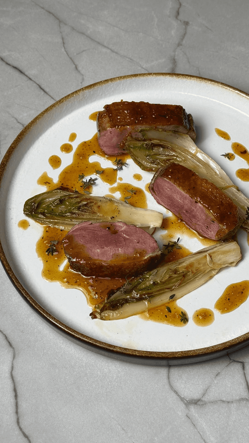 Duck breast, endive, and orange sauce